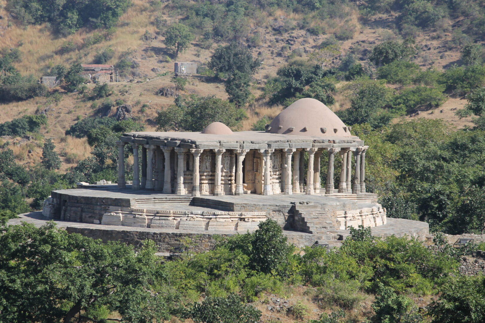 A large stone building with domed roof on top of a hill.